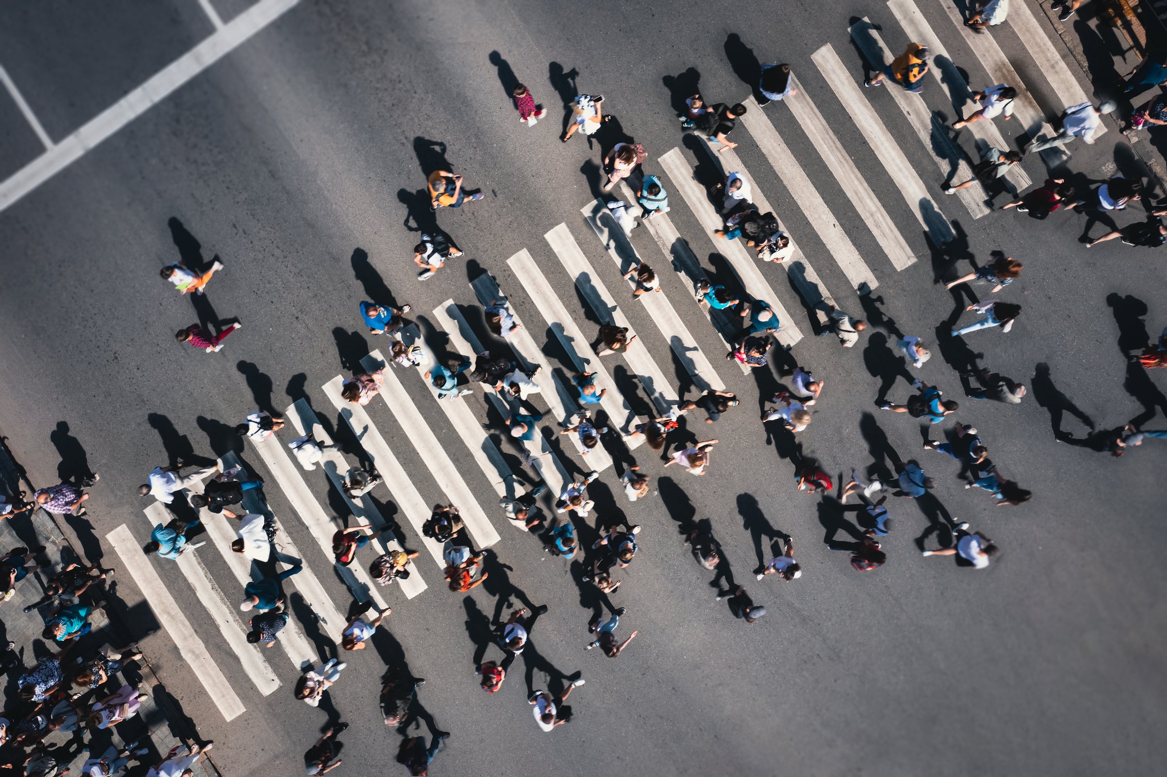Aerial view of people crossing a busy street