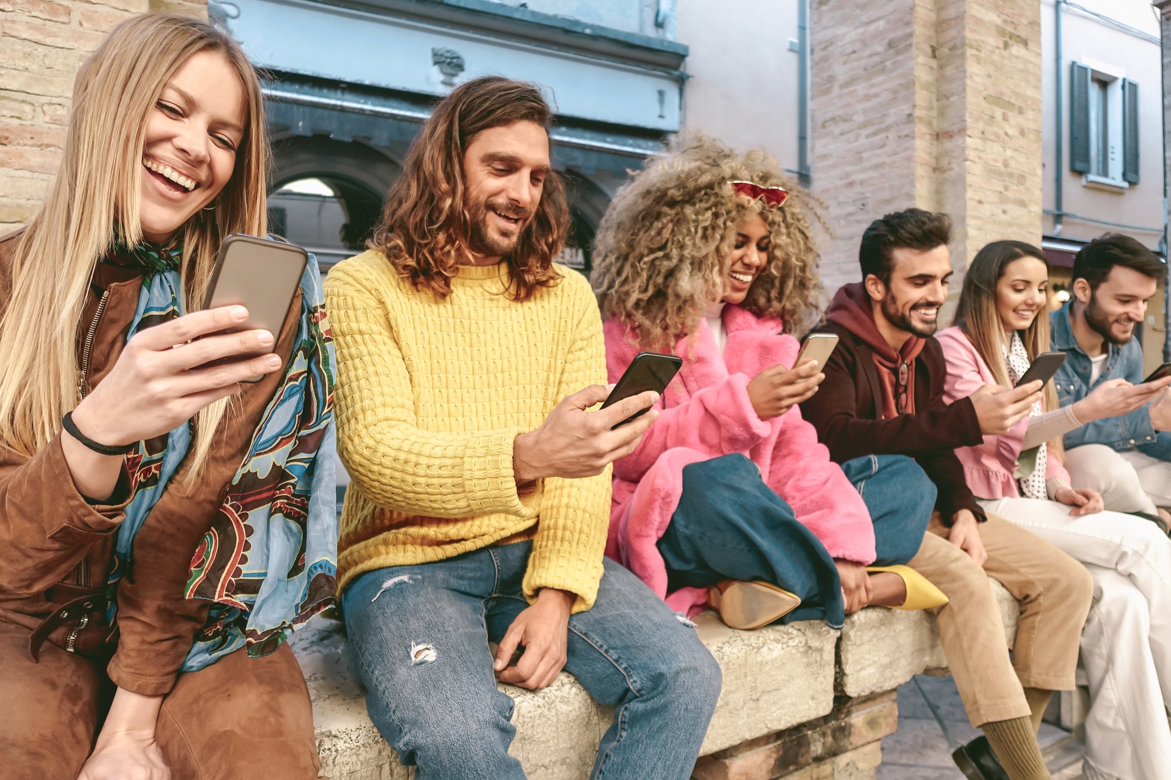 Group of friends using their phones