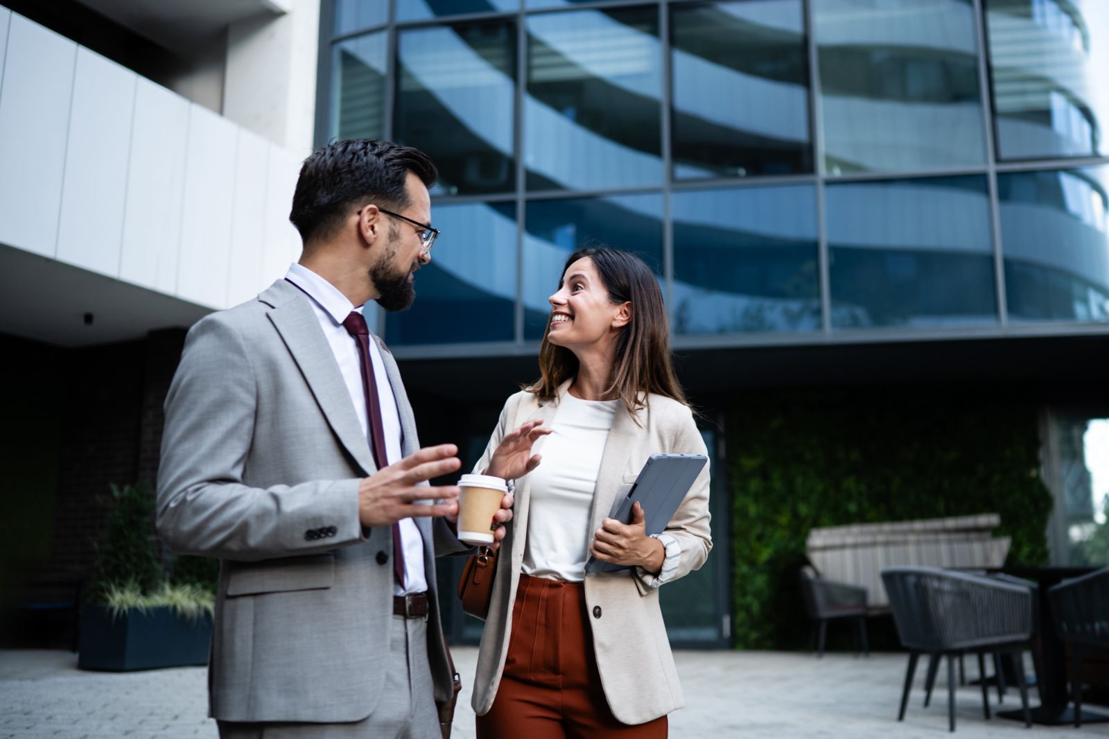 Two colleagues talking outside an office building