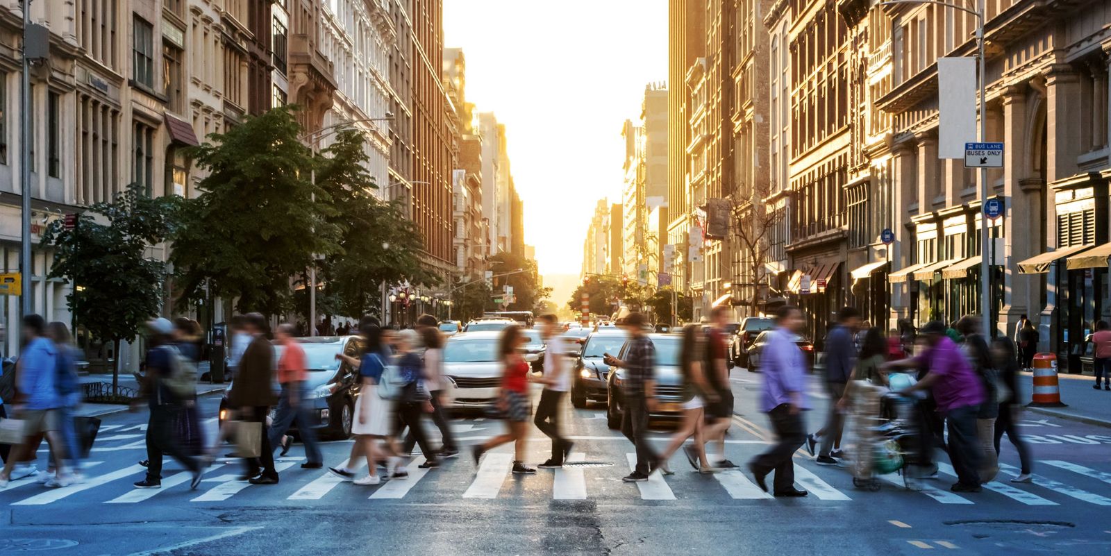 Consumers crossing a busy city street