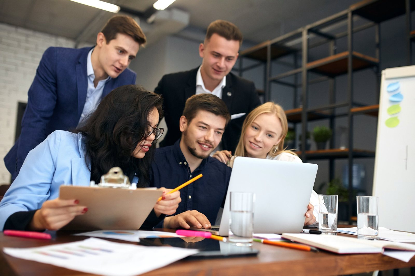 Research team reviewing findings together on a laptop